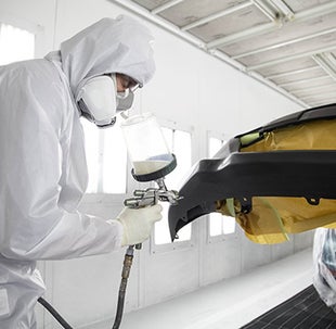 Collision Center Technician Painting a Vehicle | Oakbrook Toyota in Westmont in Westmont IL