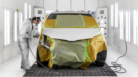 Collision Center Technician Painting a Vehicle | Oakbrook Toyota in Westmont in Westmont IL